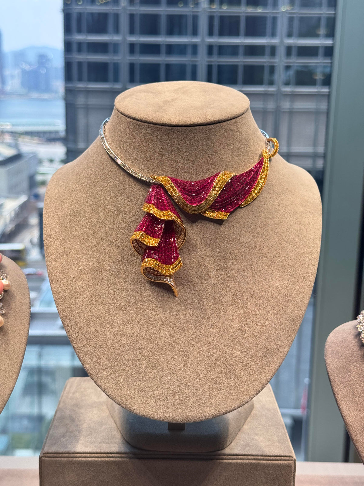 Ruby gold necklace on velvet bust