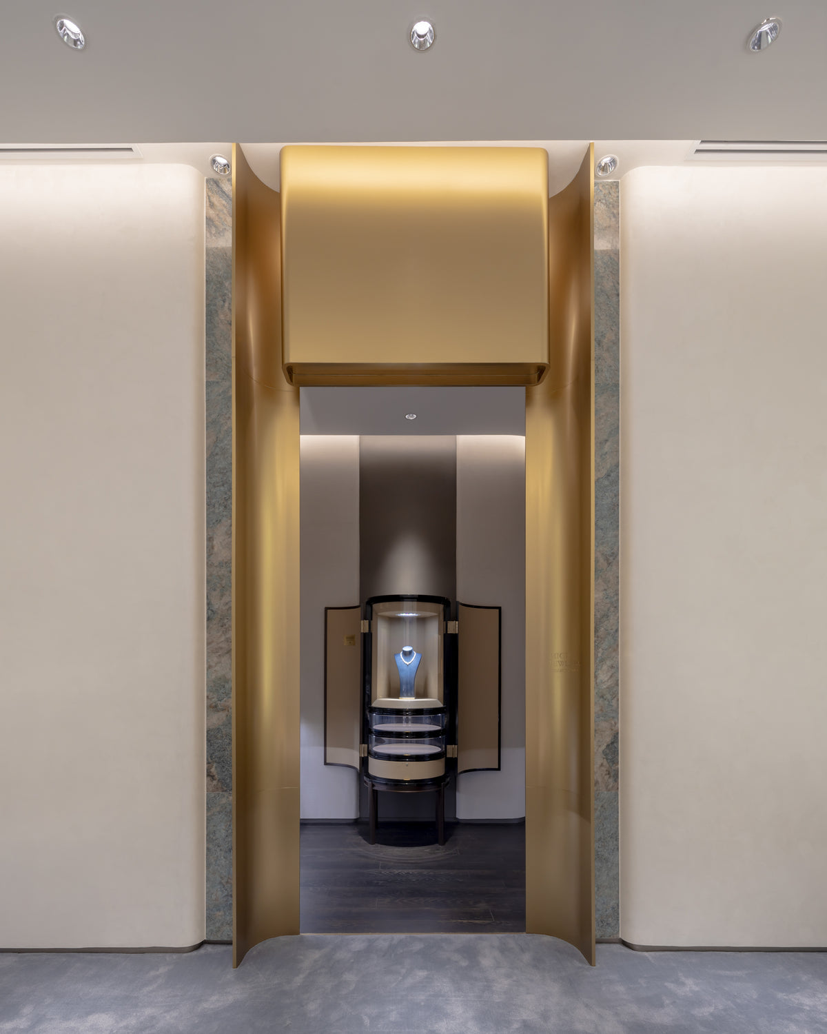 Gold arched entrance with necklace showcase