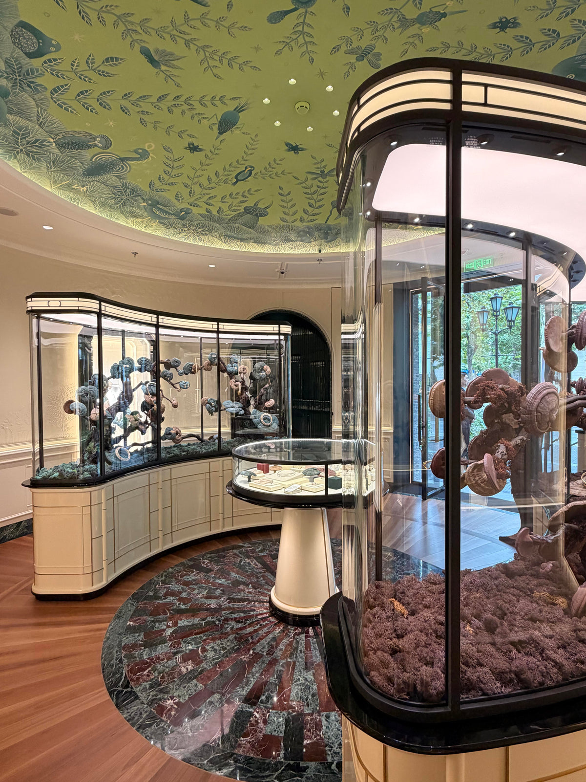 Curved glass showcases with hand-painted ceiling