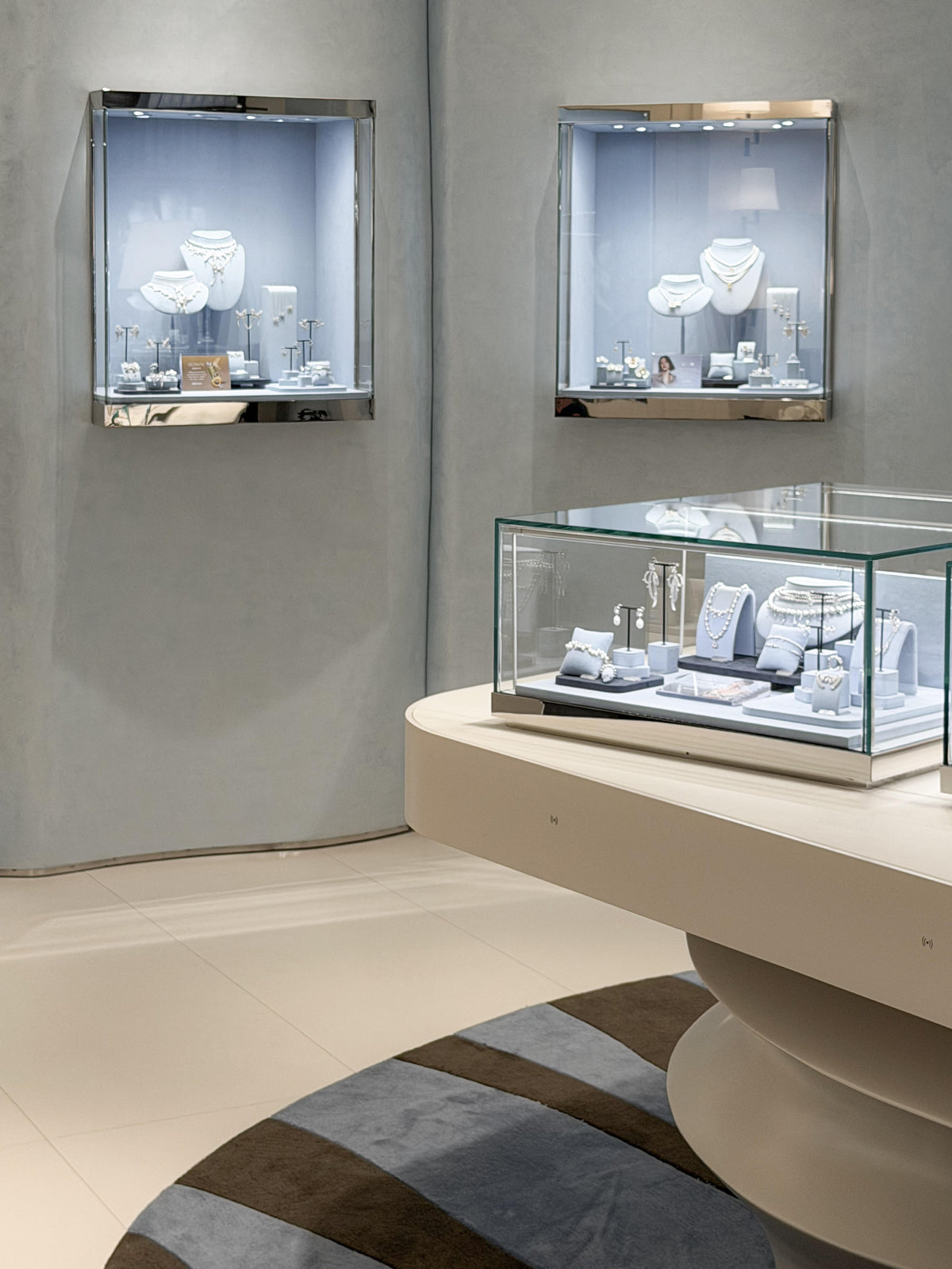 Wall-mounted glass jewelry showcases curved counter